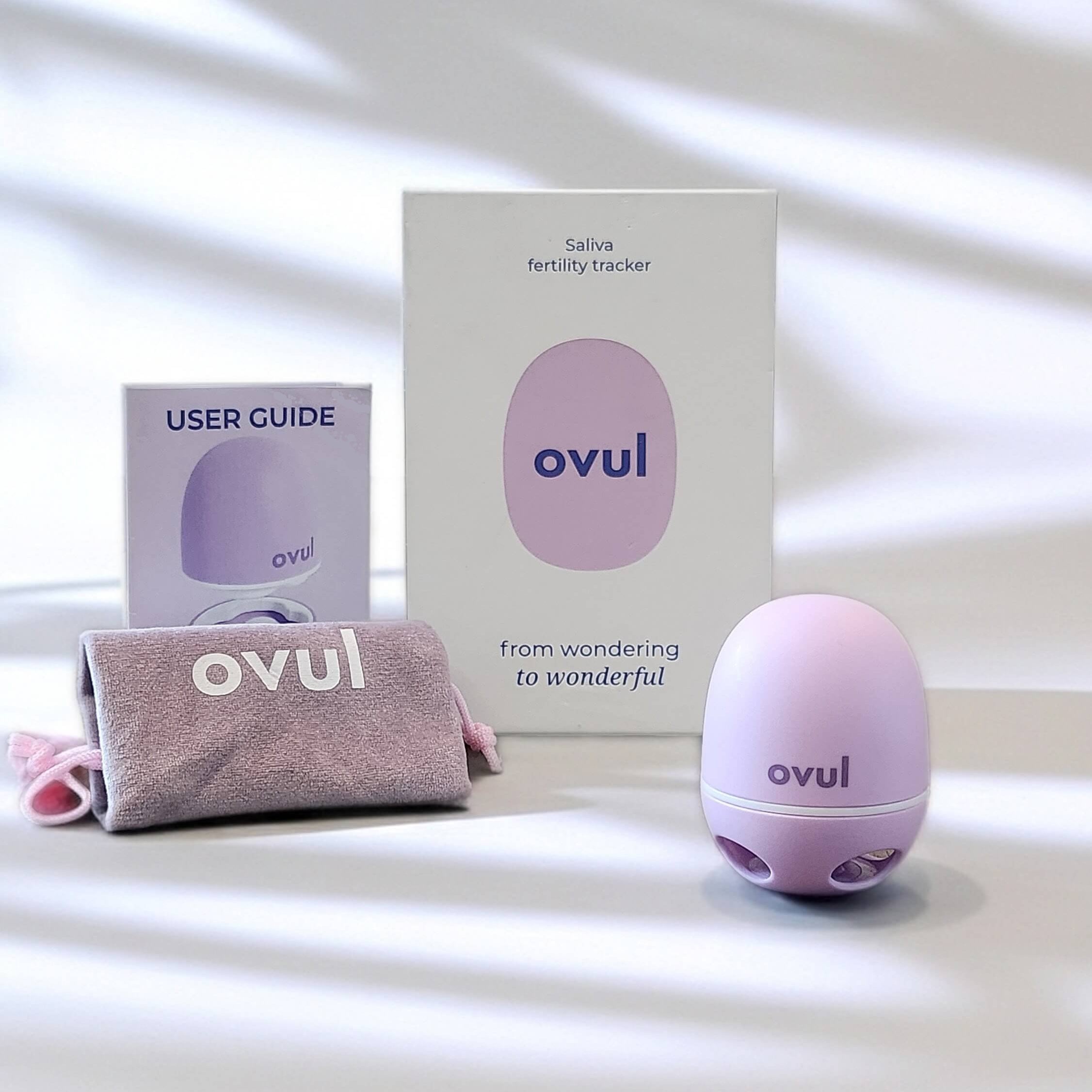 Ovul ovulation tracker set including a device, user guide, and packaging on a light background